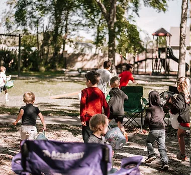 Children running across the yard at a Pillar Reformed egg hunt