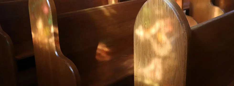 Light falling across wooden pews
