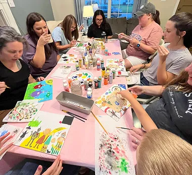 Women of Pillar Reformed painting together around a table